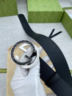 Black leather belt with silver-tone round buckle and white protective padding
