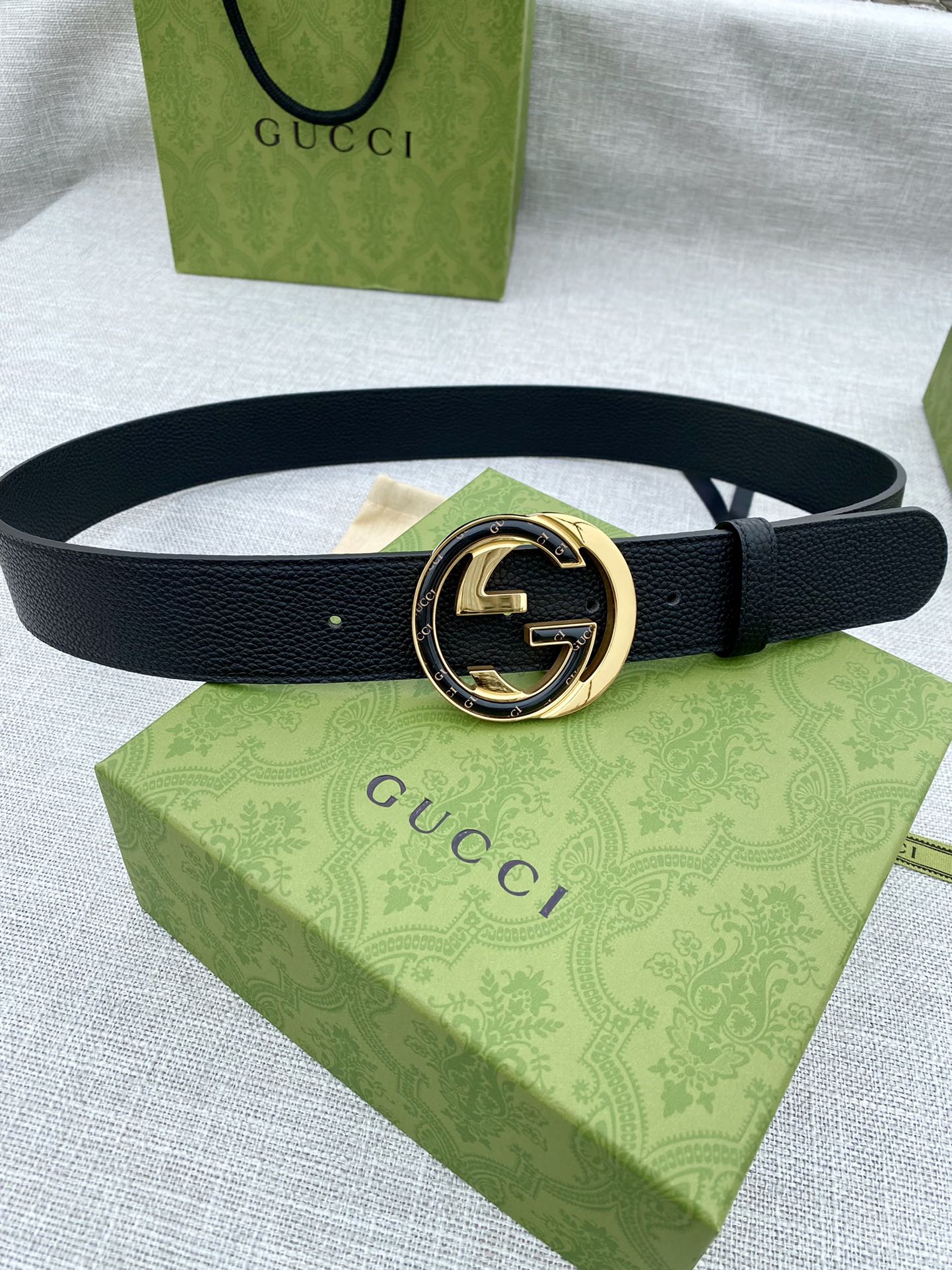 Gucci belt with black leather strap and gold-tone GG buckle
