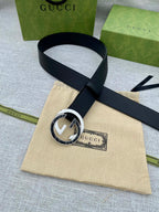 Black leather belt with silver-tone circular double G buckle and short tail