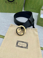 Black leather belt with gold-tone round double G buckle and attached strap