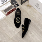 Versace black loafers, gold embroidered crest at the center