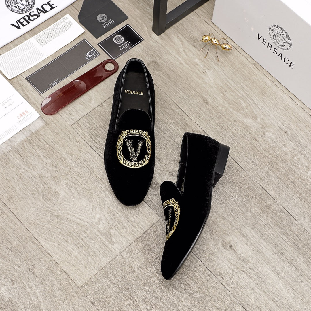 Versace black loafers, gold embroidered crest at the center