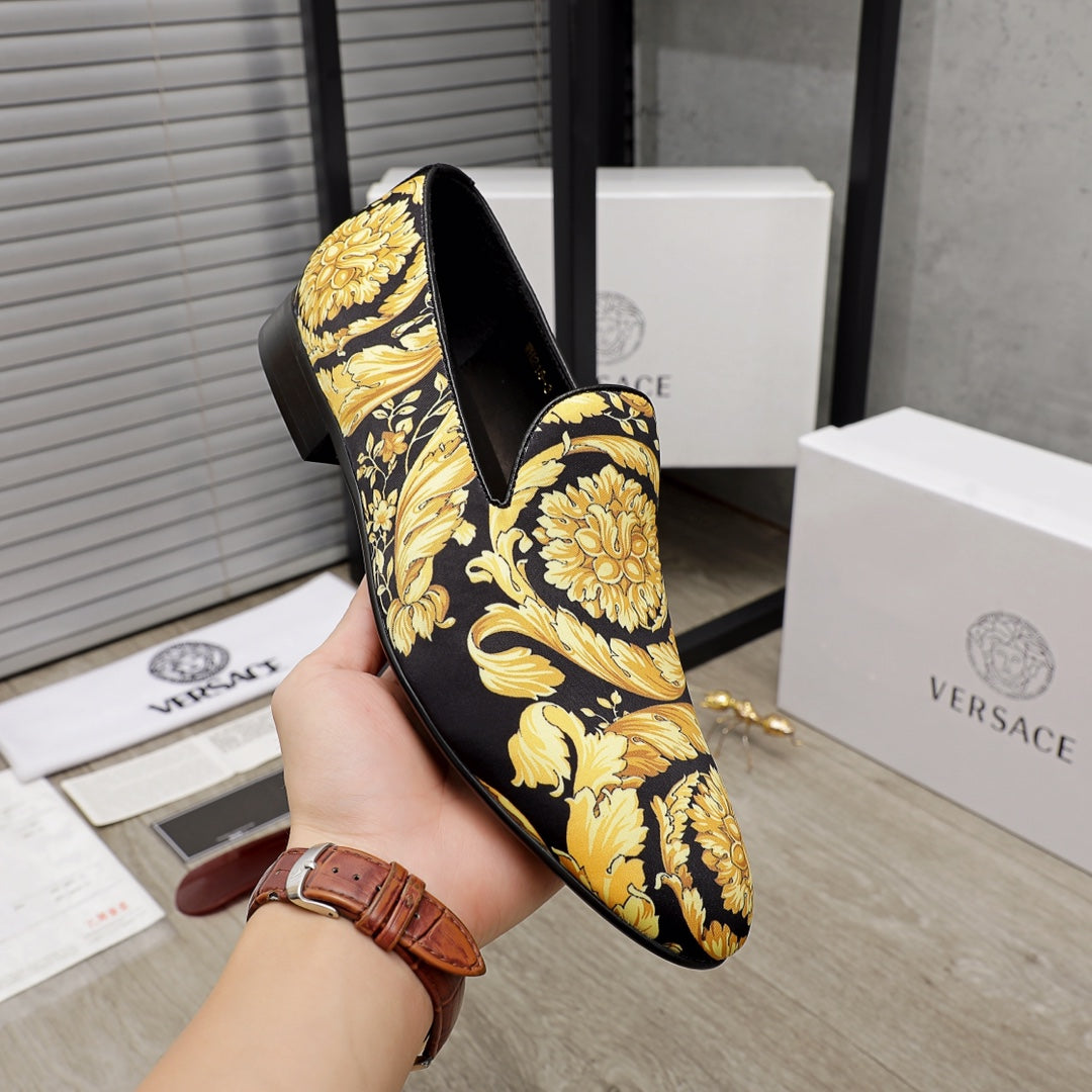 Luxury slip-on shoes with black leather-look upper and gold floral baroque pattern