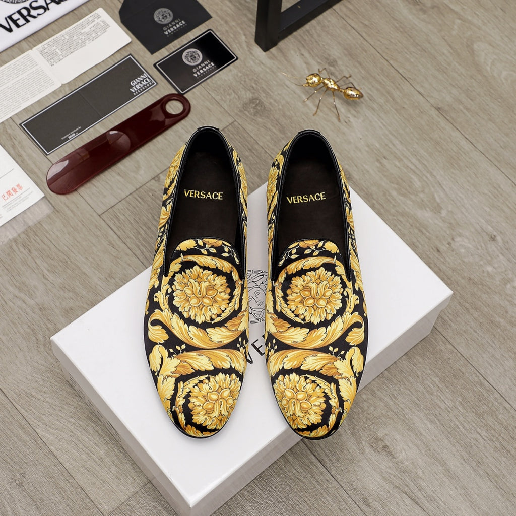 Luxury slip-on shoes with black upper and gold floral baroque print, pointed toe