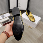 Luxury slip-on shoes inner sole view, black lining and gold baroque upper