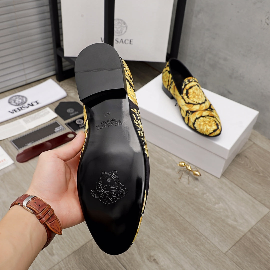 Luxury slip-on shoes inner sole view, black lining and gold baroque upper