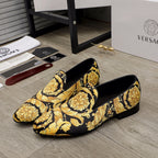 Luxury slip-on loafers in black with gold ornate floral print, low block heel, pair