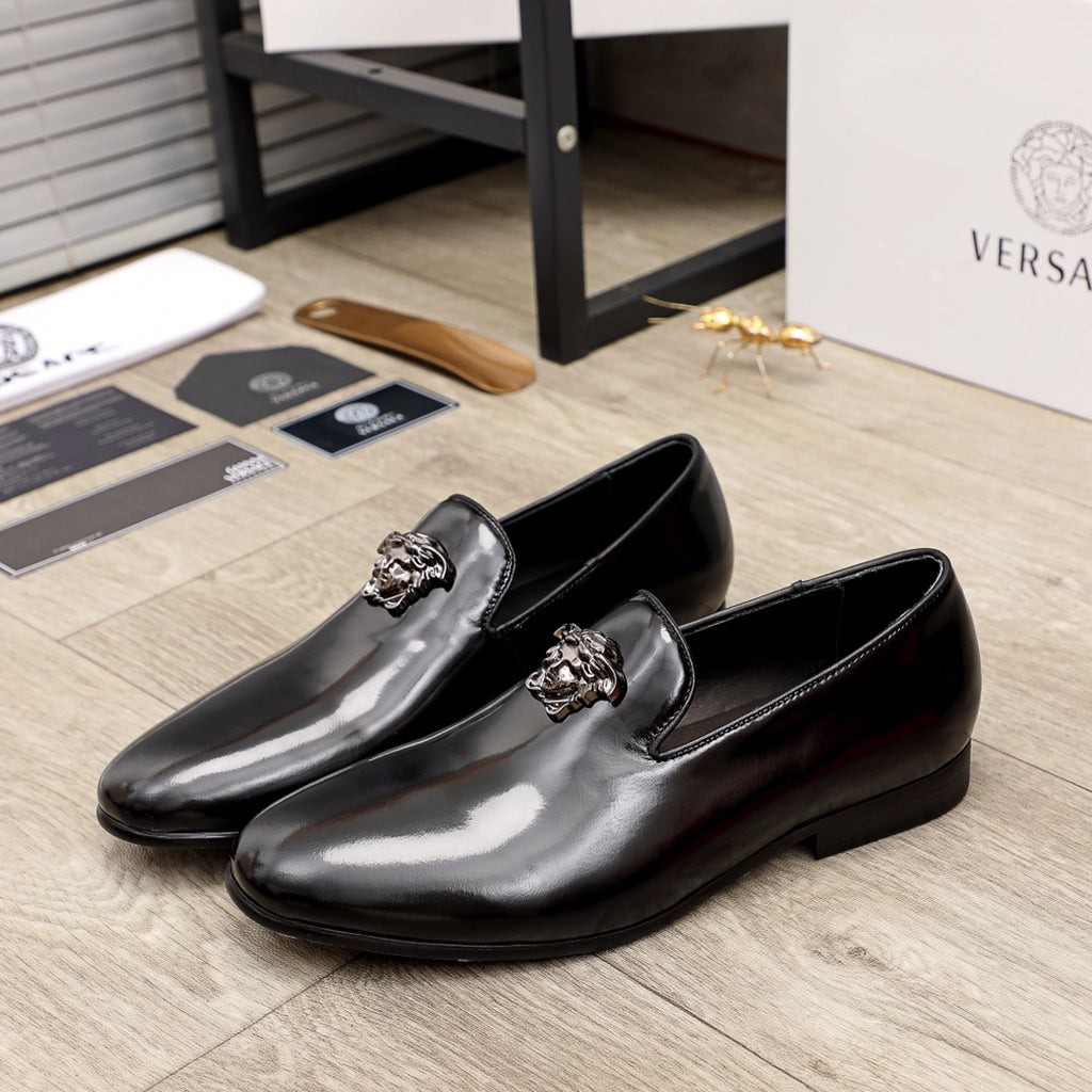 Versace black patent leather loafers with decorative lion-head bit on strap
