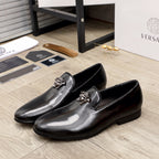 Versace black patent leather loafers with decorative lion-head bit on strap