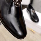 Versace black patent leather loafer toe with lion-head ornament, close-up