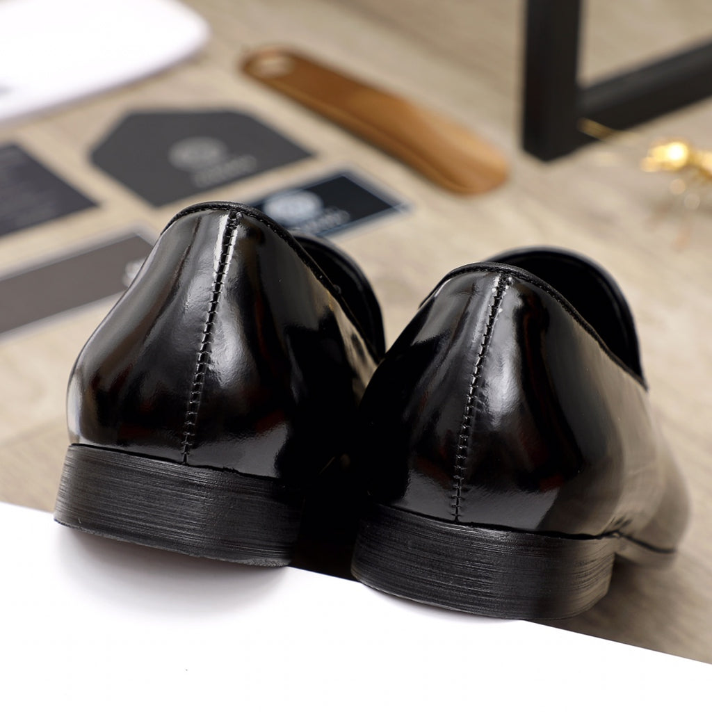 Versace black patent leather loafers, rear view showing ridged heel and stitching