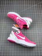 Pink basketball sneaker with white sole and textured outsole, toe and side view