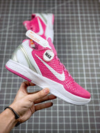 Pink basketball sneaker with white midsole and swoosh detail, front three-quarter view