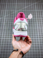 Pink basketball sneaker with white heel panel and lace loops, back view