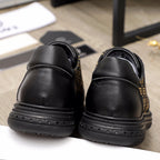 Versace sneakers heel view, black leather with textured rubber sole and rear detailing