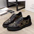 Versace sneakers, black with gold Greek key pattern and lace-up front, rubber sole