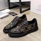 Versace sneakers, black with gold Greek key pattern and lace-up front, rubber sole