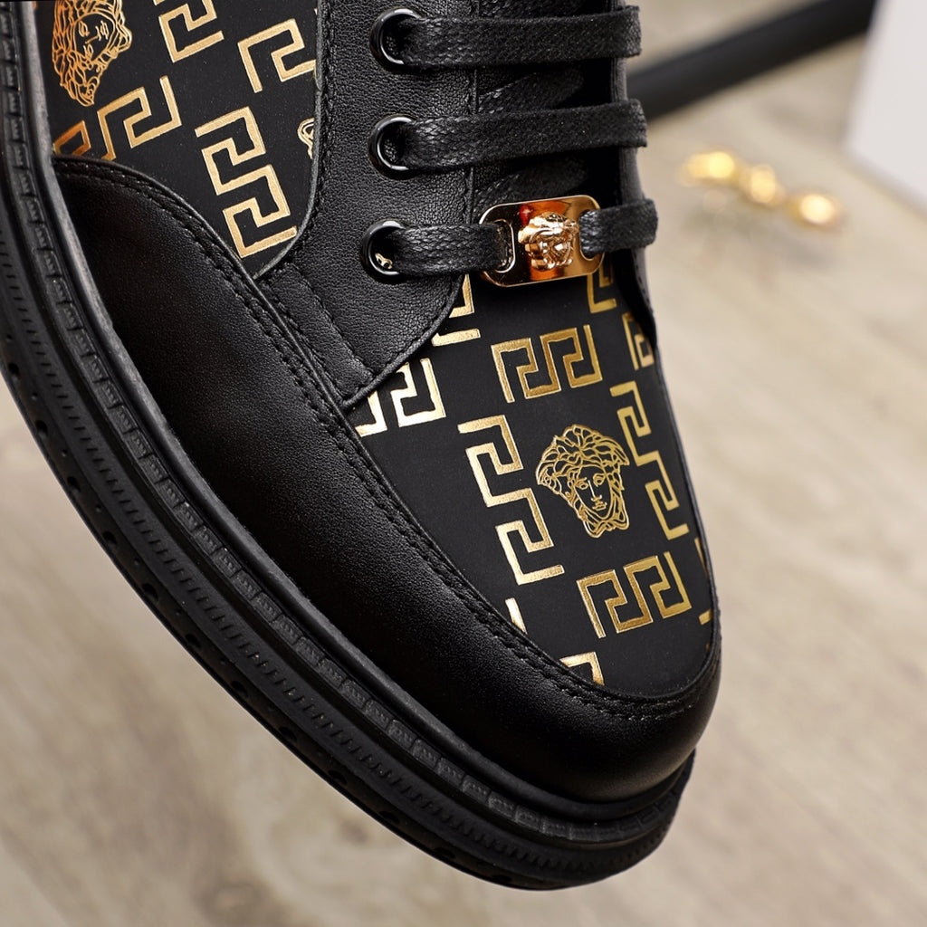 Versace sneaker upper close-up, black leather with gold pattern stripe and lace loops