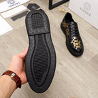Versace sneaker outsole and shoe, black tread sole with Greek key pattern