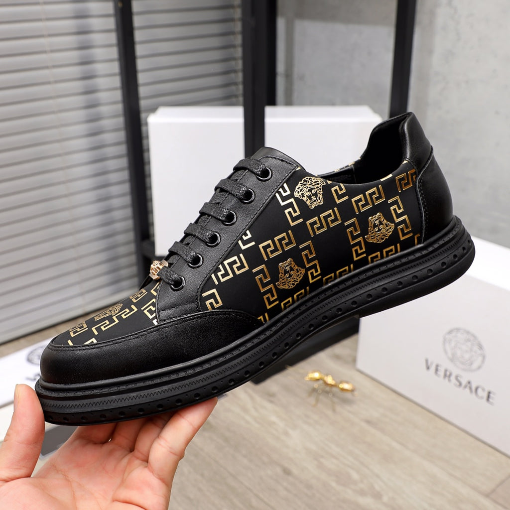 Versace low-top sneakers, black with gold medallion accents and Greek key patterned sides