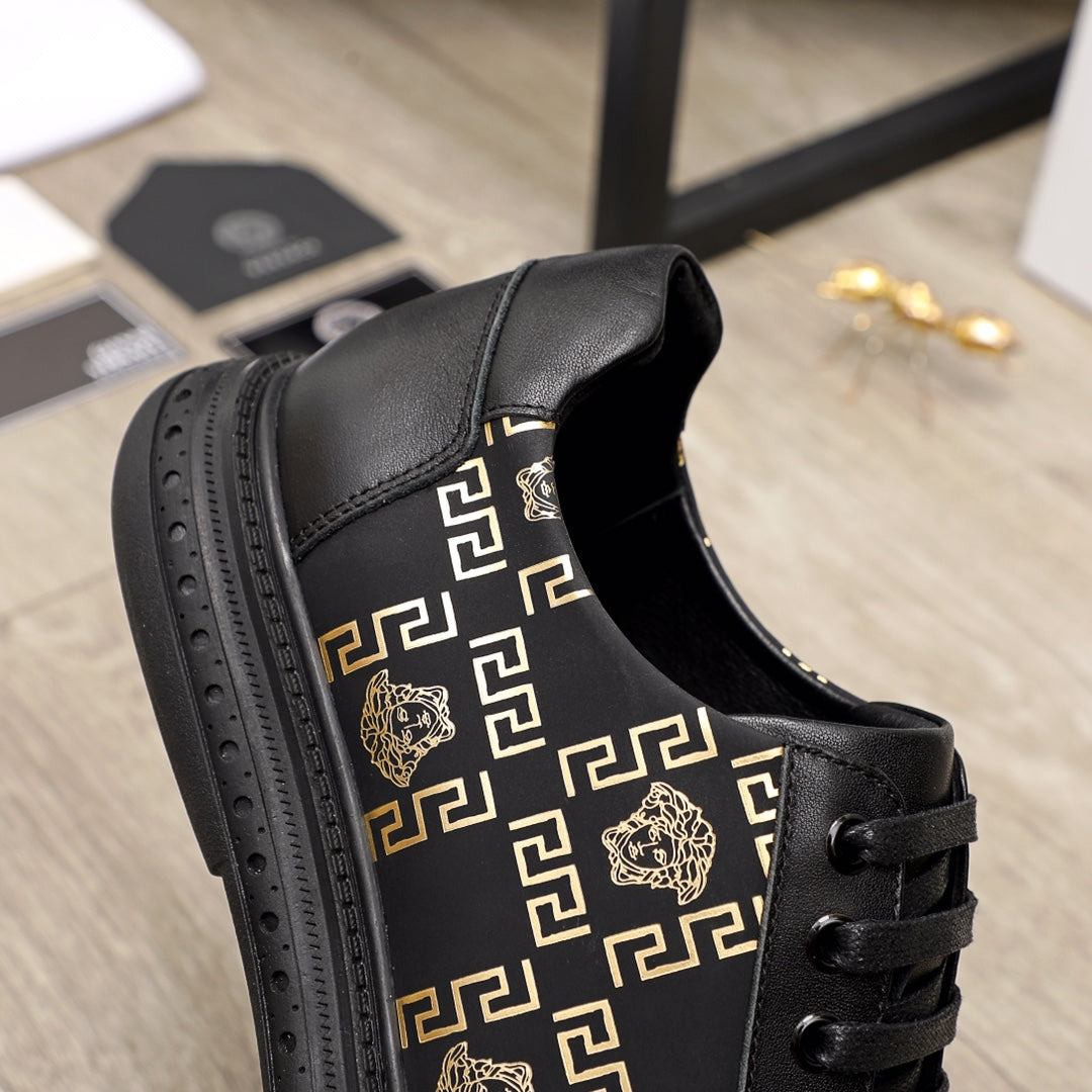 Versace sneakers side view, black leather with gold motif panel and lace-up closure