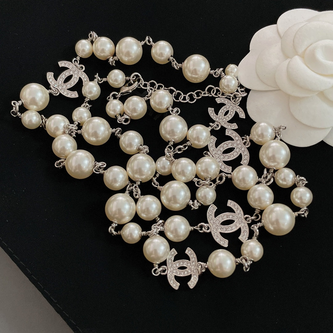 Pearl bead necklace with silver-tone links and CC logo drop charms