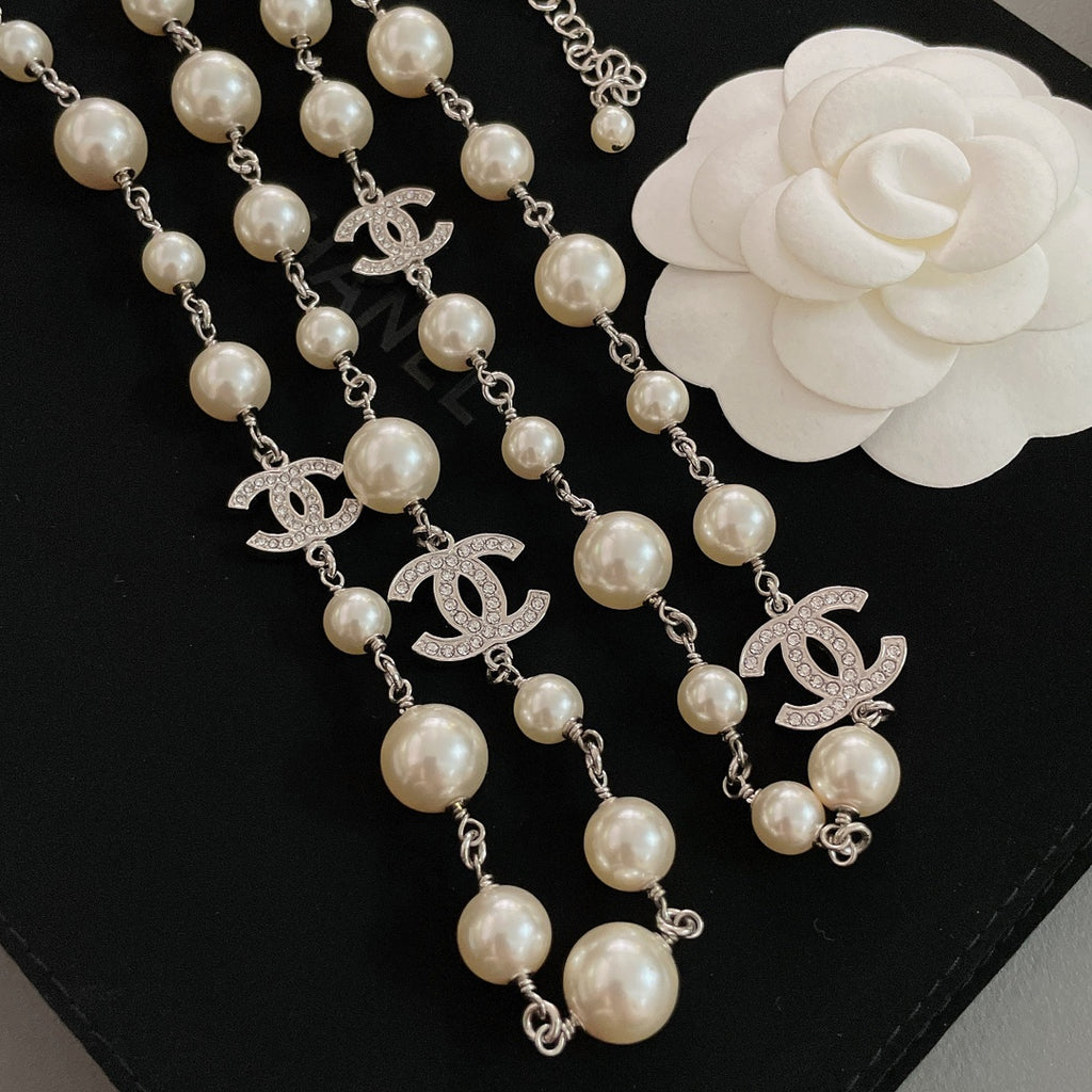 Pearl bead necklace with silver-tone chain and multiple CC logo drop charms
