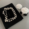 Pearl beaded necklace with silver-tone chain and interlocking CC charm