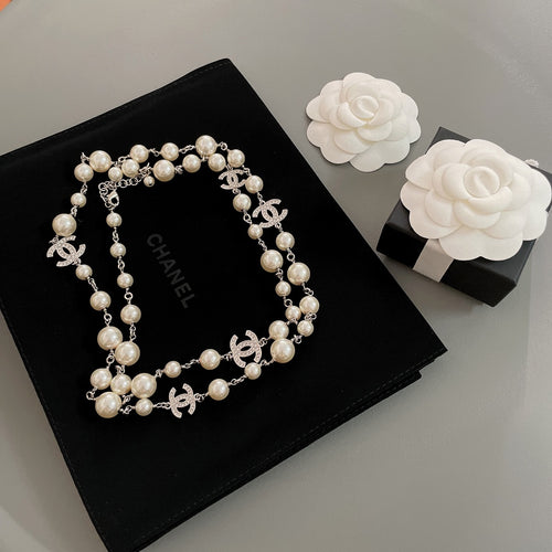 Pearl beaded necklace with silver-tone chain and interlocking CC charm