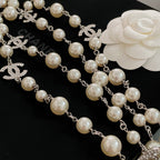 Pearl bead necklace with silver-tone chain and small CC logo emblems