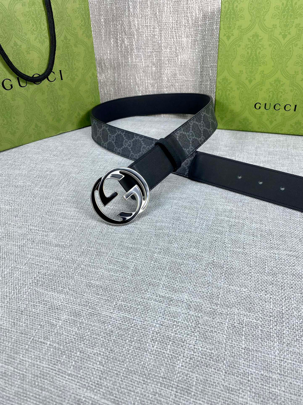 Gucci belt with dark GG monogram strap and silver-tone round double G buckle