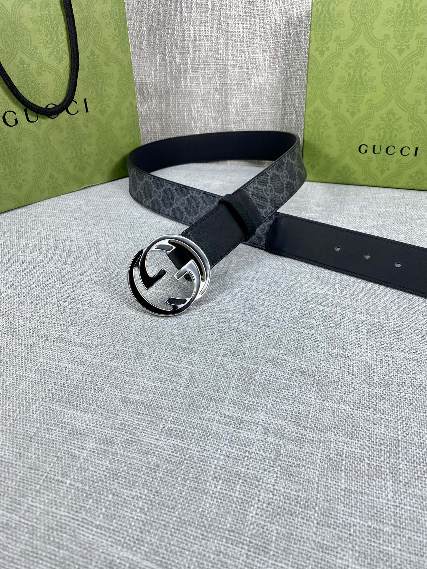 Gucci belt with dark GG monogram strap and silver-tone round double G buckle