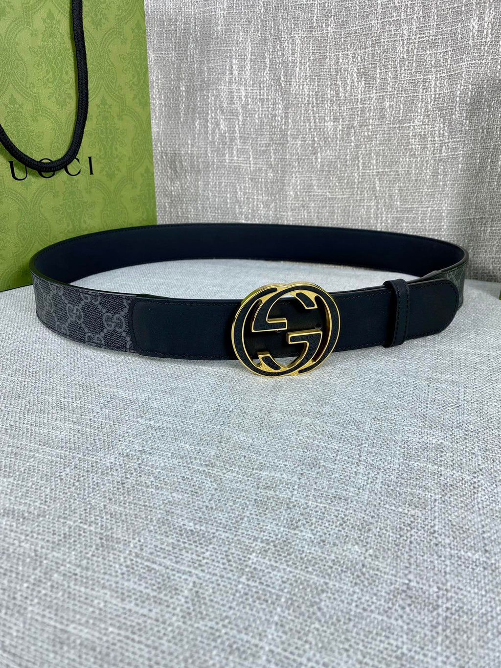 Gucci belt with dark canvas strap and gold-tone double G buckle, round shape