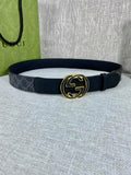 Gucci belt with dark canvas strap and gold-tone double G buckle, round shape