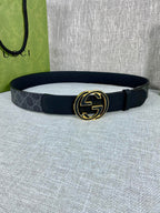 Gucci belt with dark canvas strap and gold-tone double G buckle, round shape