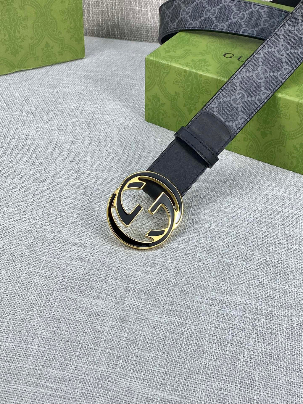 Gucci belt with dark strap and round gold-tone double G buckle