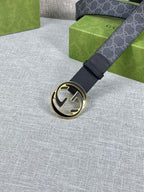 Gucci belt with dark strap and round gold-tone double G buckle