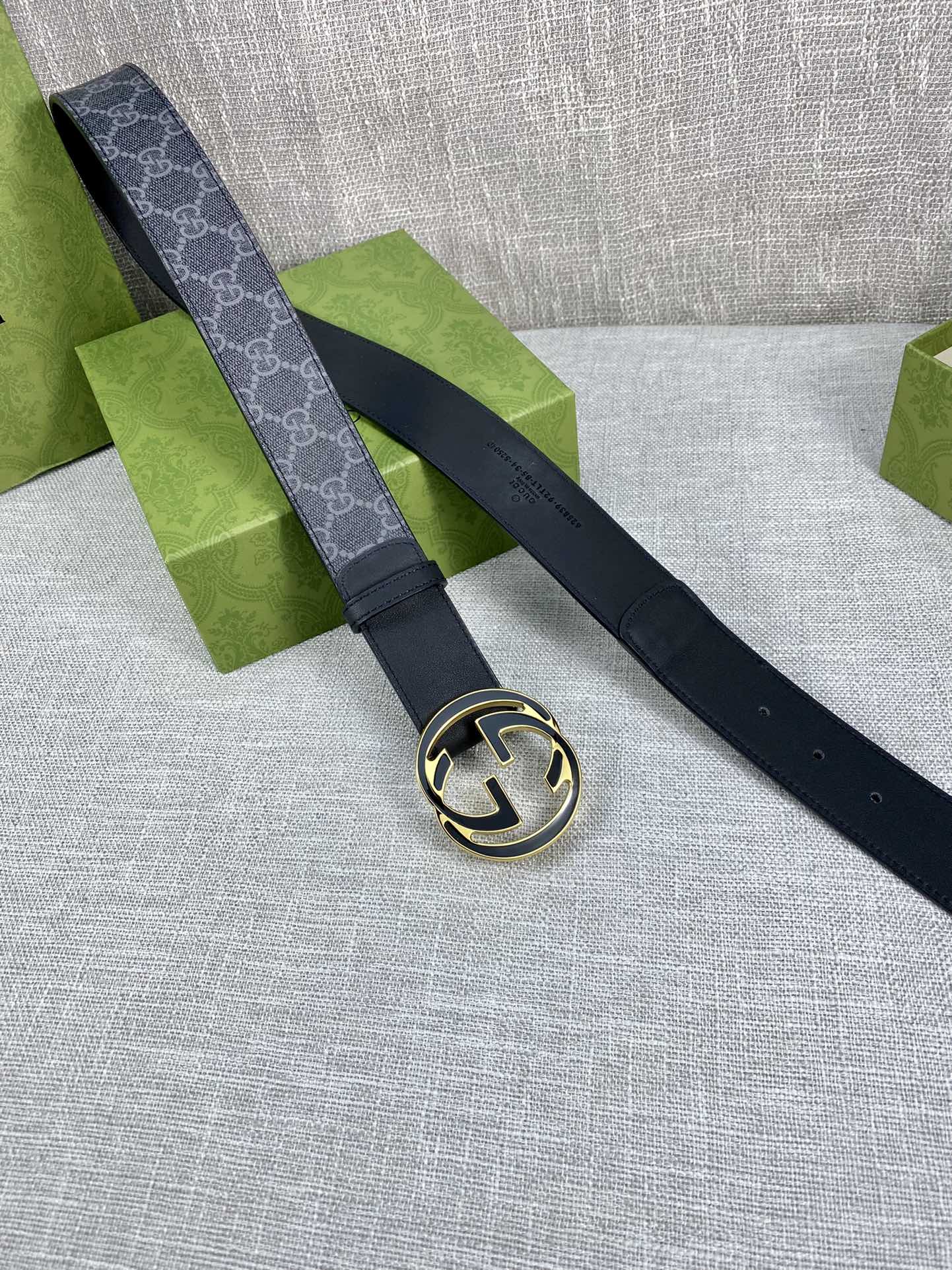 Gucci belt with dark strap and gold-tone round double G buckle