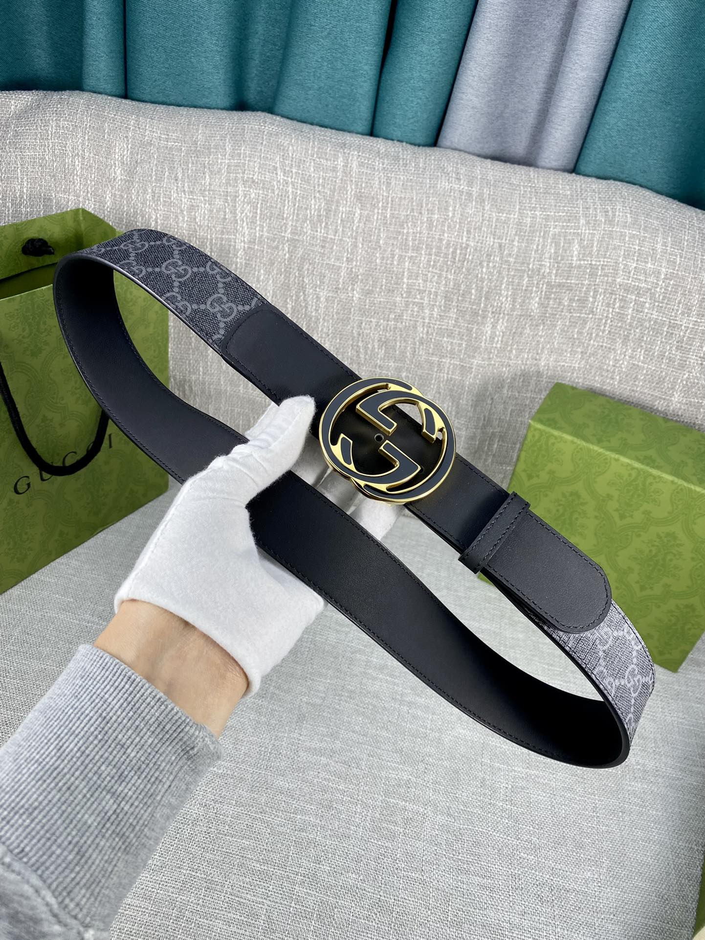 Gucci belt with navy monogram strap, gold-tone double G buckle on dark leather