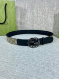 Gucci belt with dark strap and round GG buckle with dark and silver accents