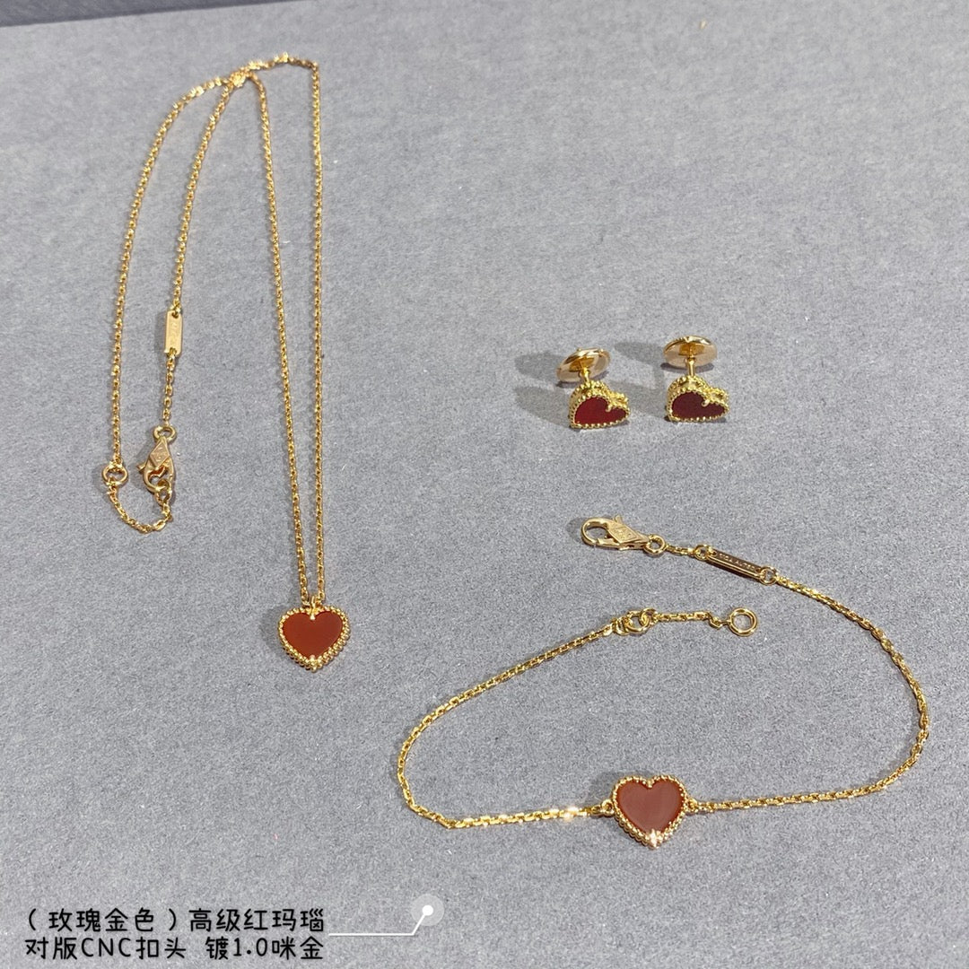 Jewelry set with heart pendant necklace, heart earrings, and gold-tone chain bracelet