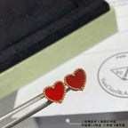Heart stud earrings with red enamel hearts and gold-tone crystal halo, held on tools