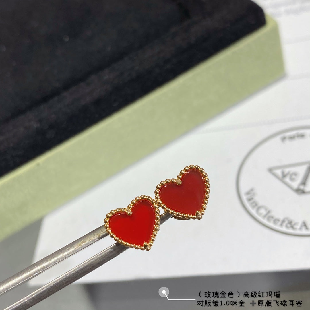 Heart stud earrings with red enamel hearts and gold-tone crystal halo, held on tools