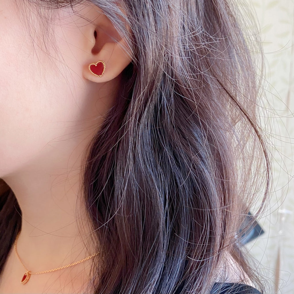 Heart stud earrings with red enamel center and gold-tone crystal border