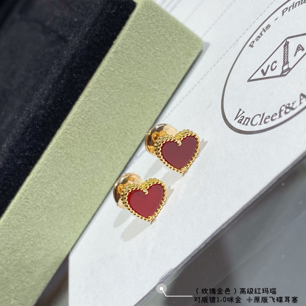 Heart stud earrings with red enamel and gold-tone crystal halo, pair on display