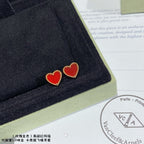 Heart stud earrings with red enamel hearts and gold-tone crystal edging