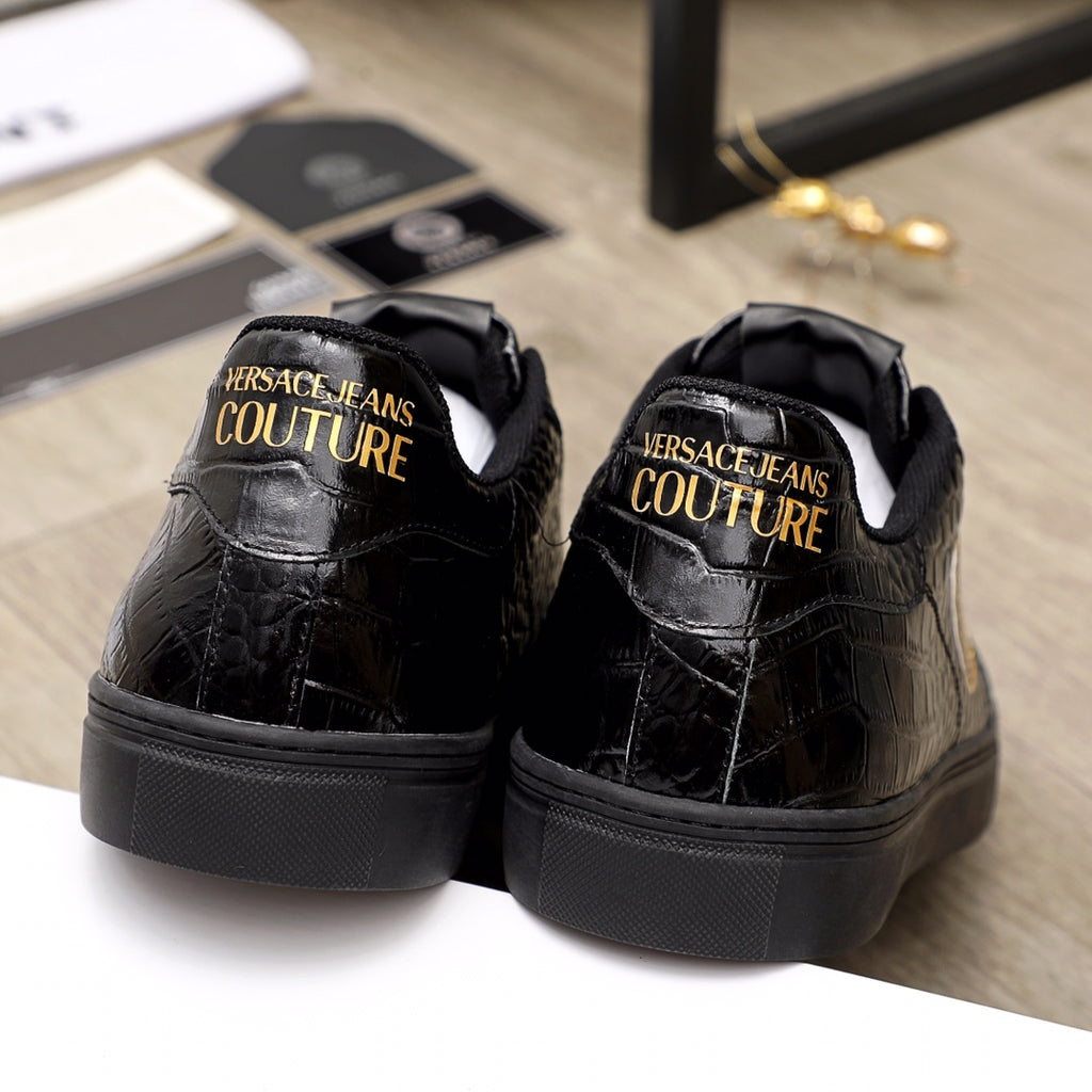Black Versace sneakers, rear view with gold 'Couture' logo text on heel