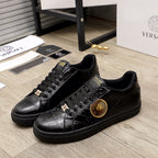 Black Versace sneakers with gold emblem and lace-up front