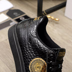 Black Versace sneakers with embossed texture, gold logo medallion and lace-up