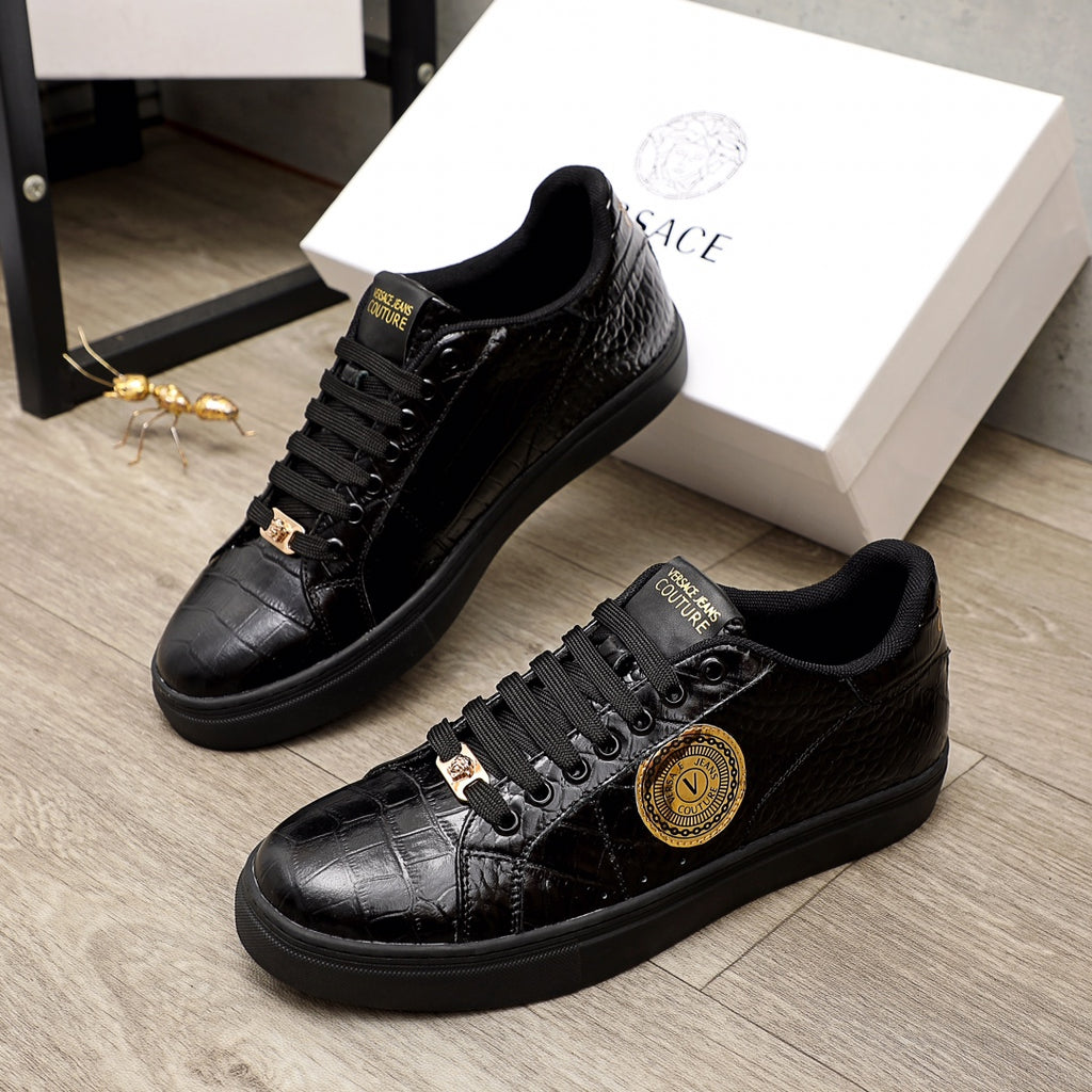 Black Versace lace-up sneakers with gold crest emblem, leather-textured upper